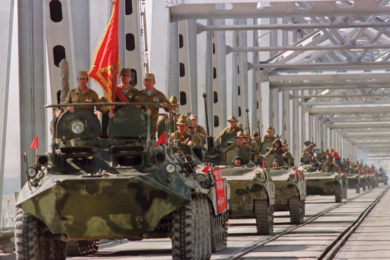 'TERMEZ, RUSSIA - MAY 21:  A convoy of Soviet Army armoured personal vehicles cross a bridge in Termez, 21 May 1988 at Soviet-Afghan border, during the withdrawal of the Red Army from Afghanistan. The