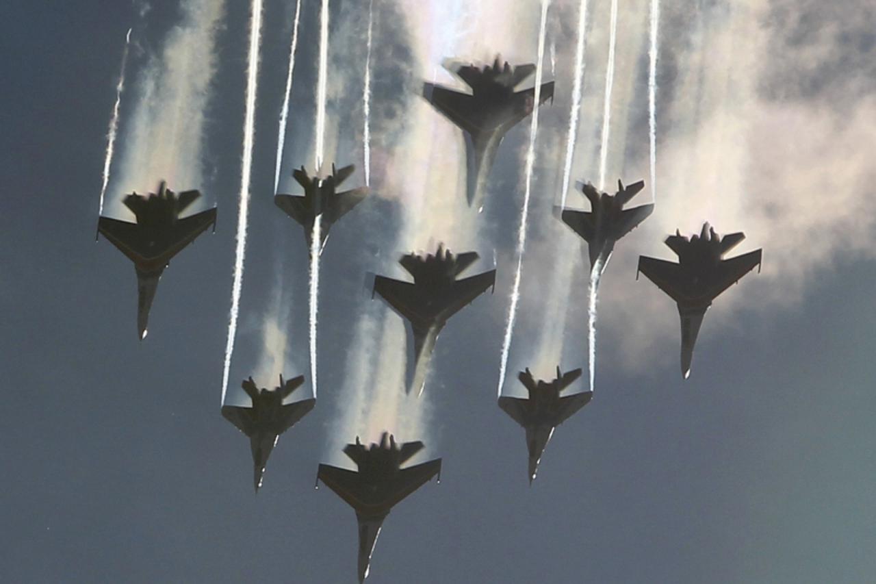 'MiG-29 jet fighters of the Strizhi (Swifts) and Sukhoi Su-27 jet fighters of the Russkiye Vityazi (Russian Knights) aerobatic teams perform during a demonstration flight at the MAKS International Avi